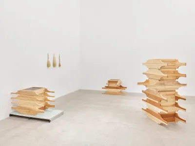 Stacks of wood in a gallery.