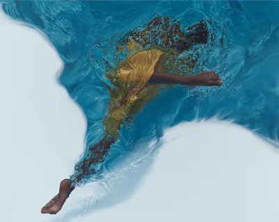 A Black woman swimming through water. She is seen from below, with her feet kicking through and seemingly out of the water.