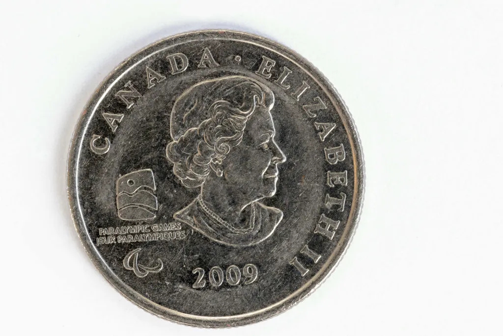 A Canadian coin featuring an image of a woman in profile.