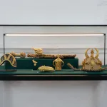 Golden artifacts in a glass display case.