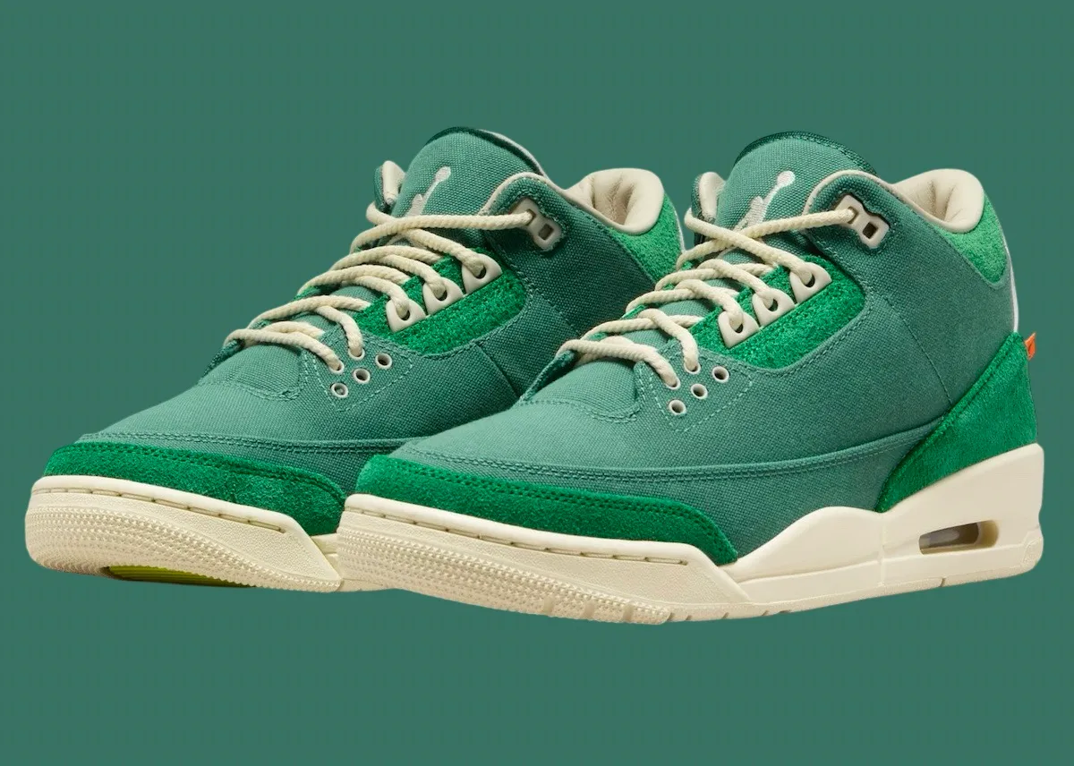 A pair of green suede sneakers set against a green background.