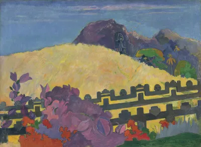 A straw-colored mountaintop with a fence in front of it. Before the fence is a purple and red grouping of flowers.