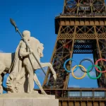 Olympic rings on the Eiffel Tower near the restored statue Cavalier Arabe (Arab rider) on the Pont d