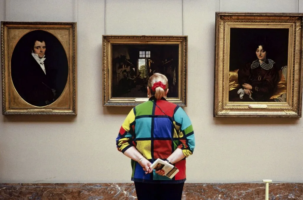 FRANCE - CIRCA 1993:  The Louvre Museum in Paris, France in 1993 - A woman with a 