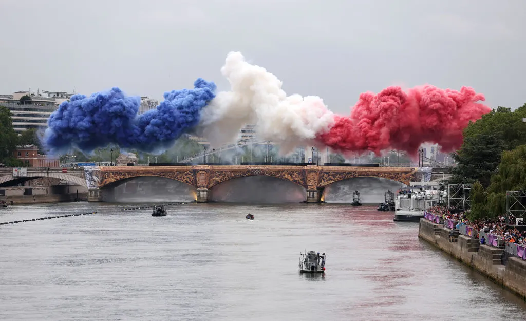 PARIS, FRANCE - JULY 26: Smoke resembling the flag of Team France is shown over Pont d』Austerlitz during the opening ceremony of the Olympic Games Paris 2024 on July 26, 2024 in Paris, France. (Photo by Lars Baron/Getty Images)