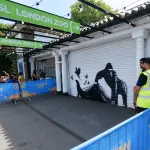 An artwork of a black gorilla on a shutter.