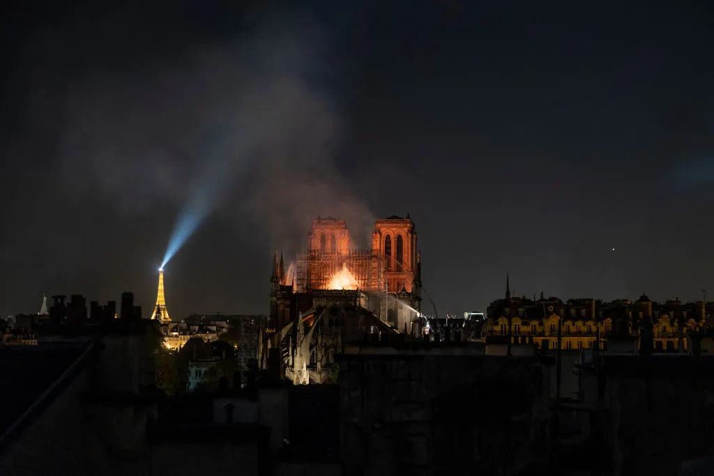 PARIS, FRANCE - APRIL 15: Smoke and flames rise from Notre-Dame Cathedral on April 15, 2019 in Paris, France. A fire broke out on Monday afternoon and quickly spread across the building, collapsing the spire. The cause is yet unknown but officials said it was possibly linked to ongoing renovation work. (Photo by Veronique de Viguerie/Getty Images)