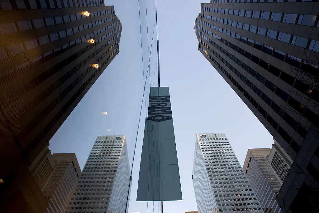 The glass facade of the newly expanded and renovated Museum of Modern Art, reflects the surrounding buildings. The new MoMA, designed by architect Yoshio Tanigchi, is twice as large as before and cost 5 million to be built. (Photo by James Leynse/Corbis via Getty Images)