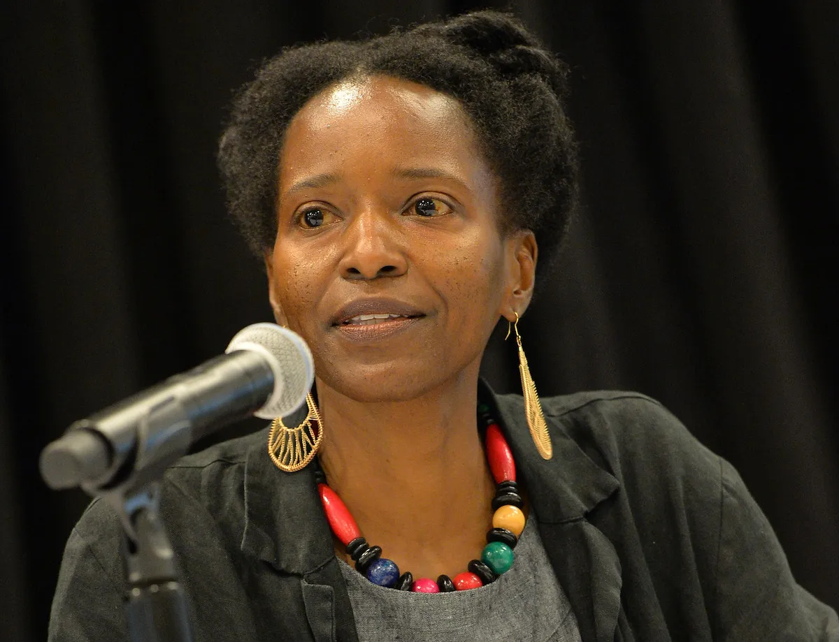 A Black woman speaking into a microphone.