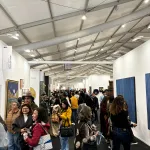 The crowded aisles of an art fair.