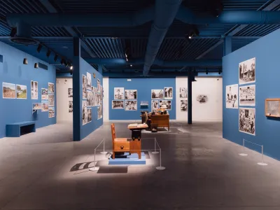 A gallery with various dioramas and pictures hung on its walls.