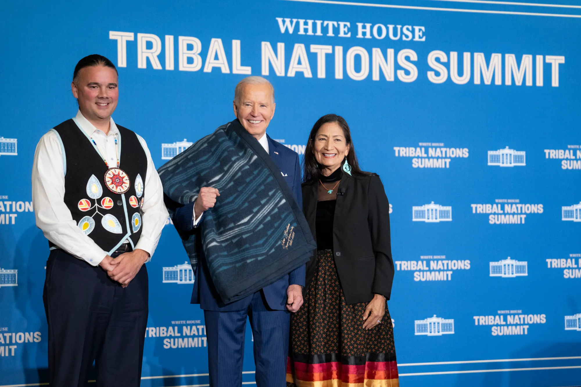 Secretary of the Interior Deb Haaland and Assistant Secretary for Indian Affairs Bryan Newland present a ceremonial blanket to President Joe Biden at the Tribal Nations Summit, Monday, December 9, 2024, at the Department of the Interior in Washington, D.C. (Official White House Photo by Adam Schultz)