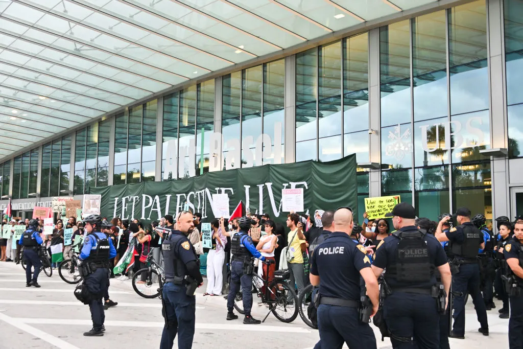 MIAMI BEACH, FLORIDA - DECEMBER 08: Protestors from the South Florida Coalition for Palestine demonstrate for a ceasefire in the Israel-Hamas conflict at Art Basel Miami Beach 2023 at the Miami Beach Convention Center on December 08, 2023 in Miami Beach, Florida. (Photo by Dave Benett/Jed Cullen/Dave Benett/Getty Images)