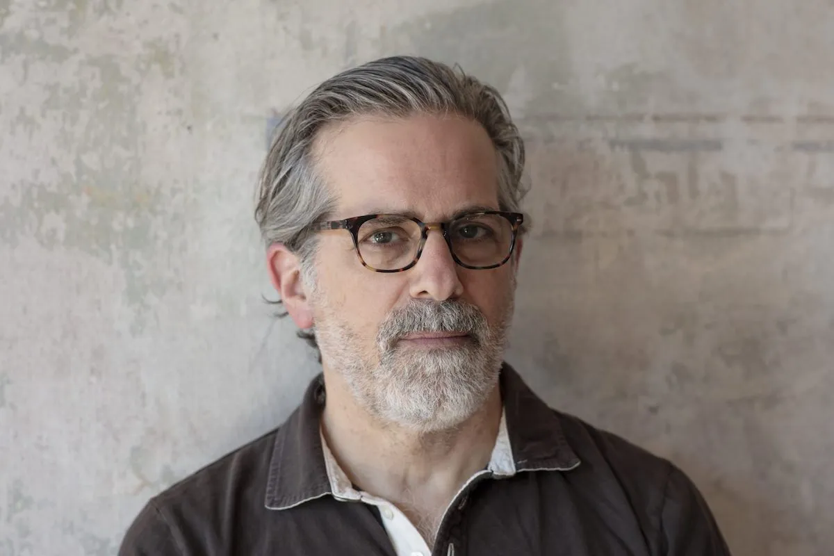 A white man in glasses with graying hair and beard.