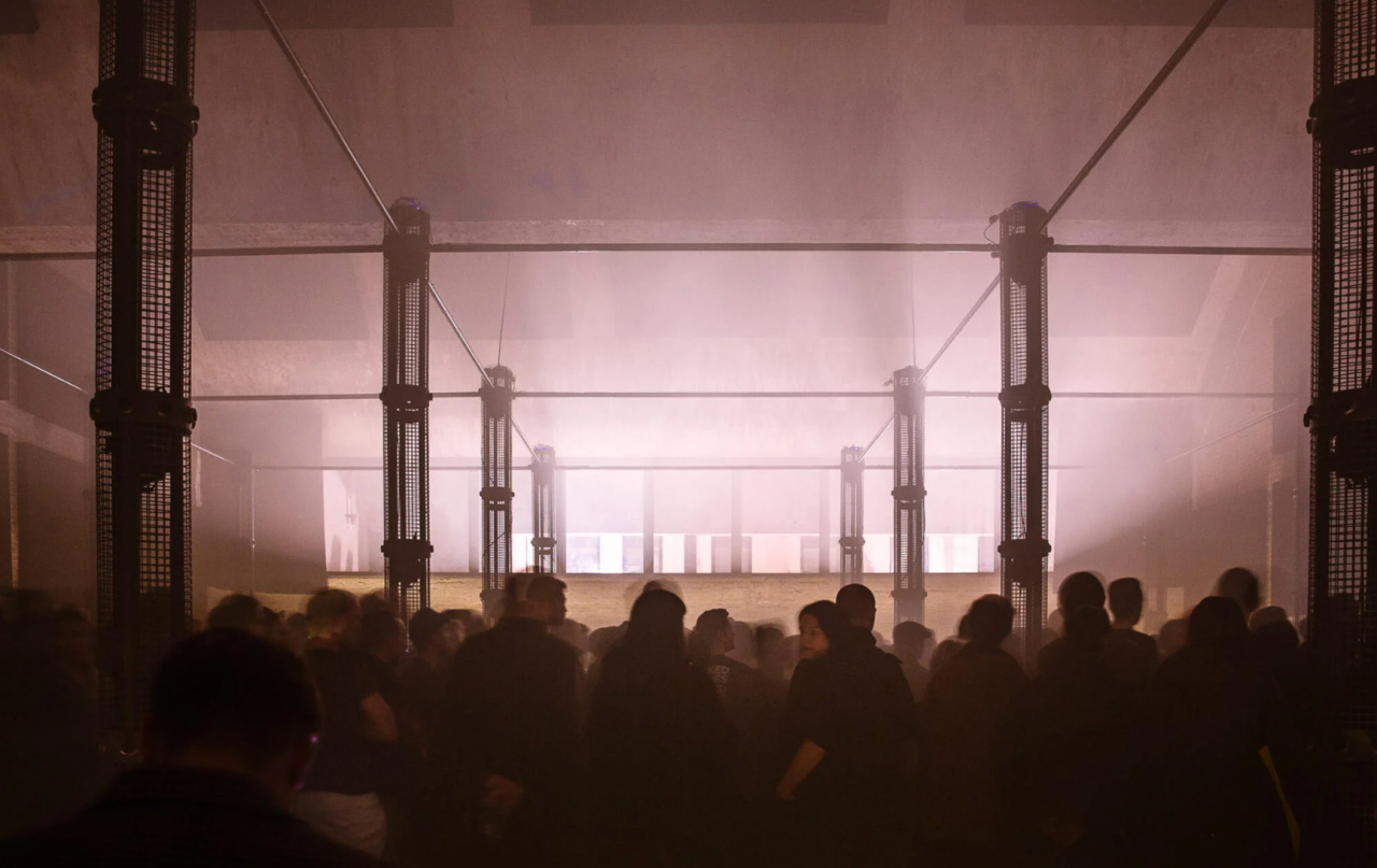 People dancing in a smoke-filled night club.